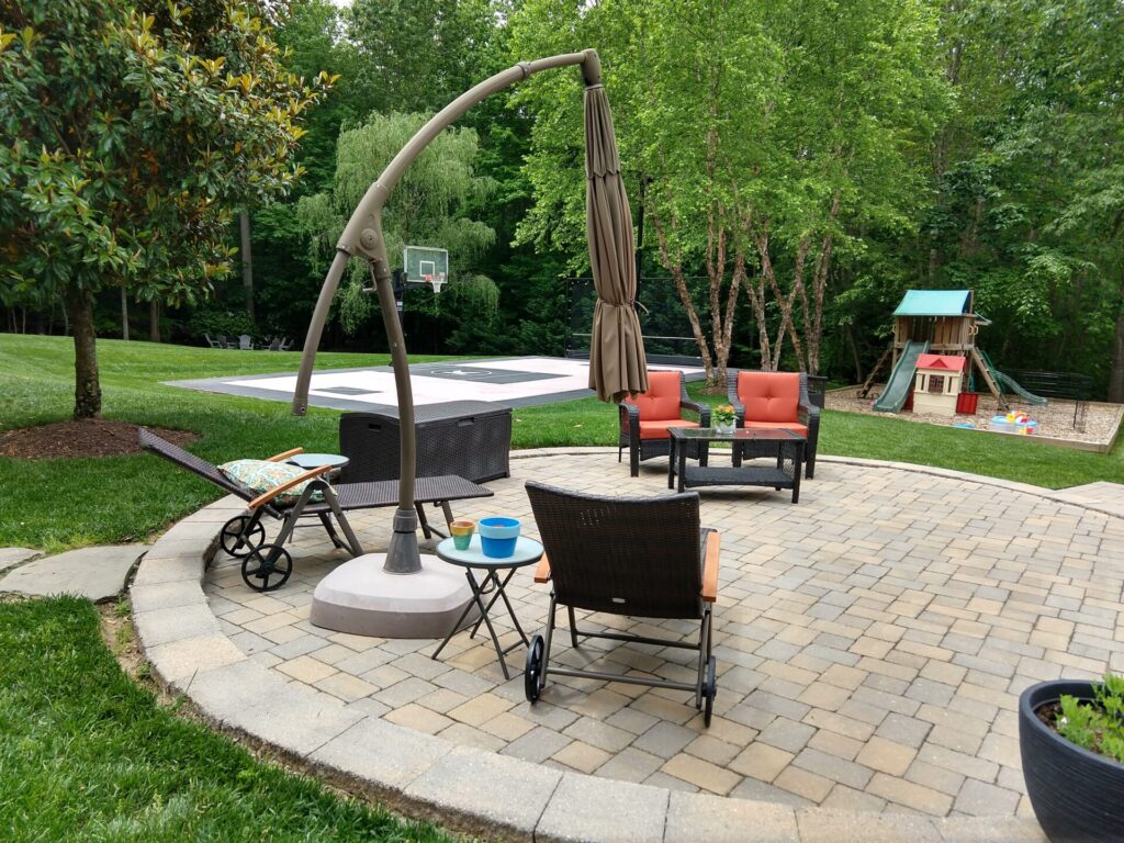 Hardscape seating area and basketball court in the sunniest part of the yard. 