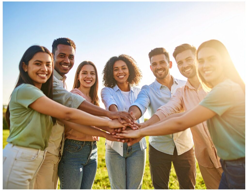 group of people with hands overlapping