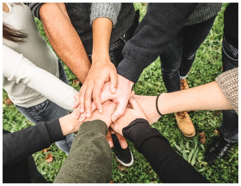 hands together over grass