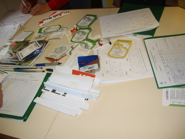 scattered seed packets and note paper on a table